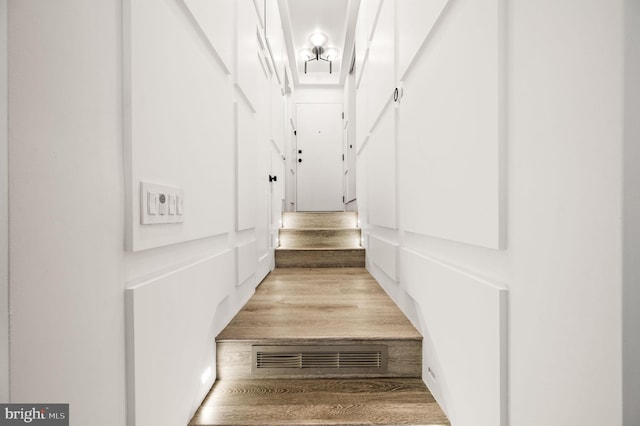 staircase featuring light wood-type flooring