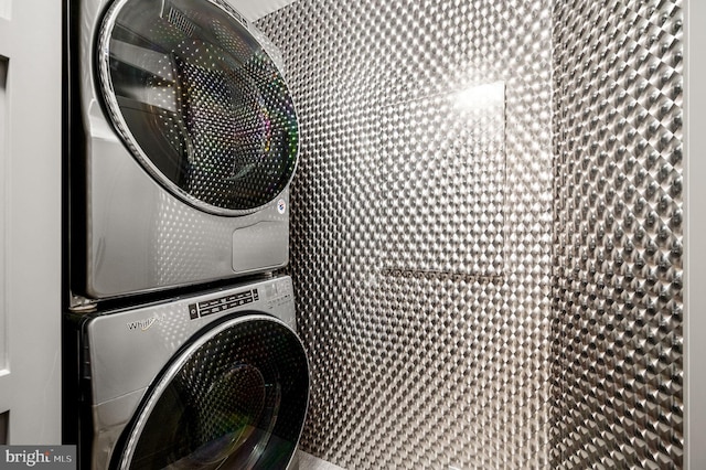 laundry room with stacked washer / drying machine