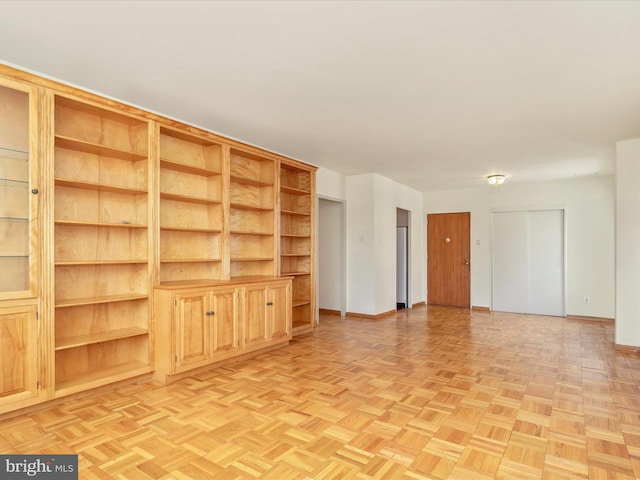 unfurnished living room with light parquet floors