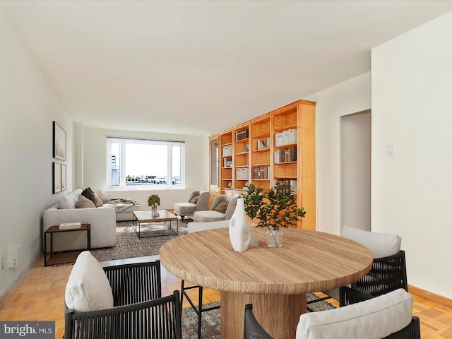 dining space featuring light parquet flooring