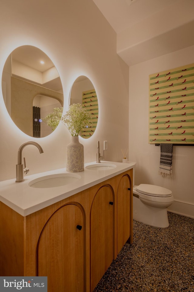 bathroom featuring vanity and toilet