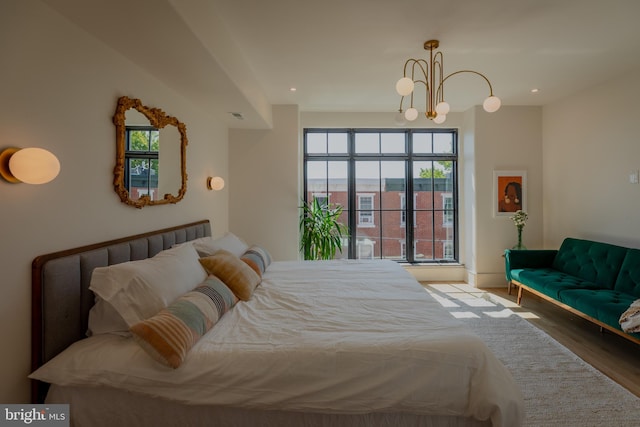 bedroom featuring a chandelier and hardwood / wood-style flooring