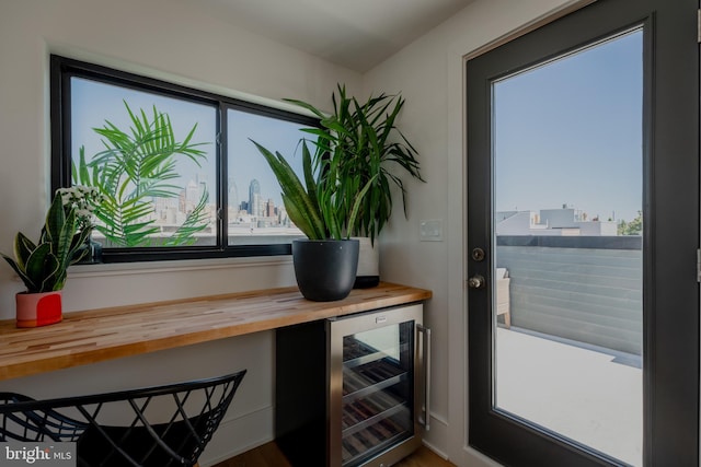 interior space with beverage cooler and bar