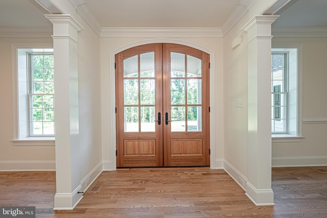 entryway with plenty of natural light, light hardwood / wood-style flooring, and french doors