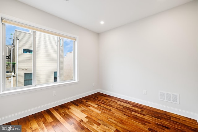 spare room with wood-type flooring