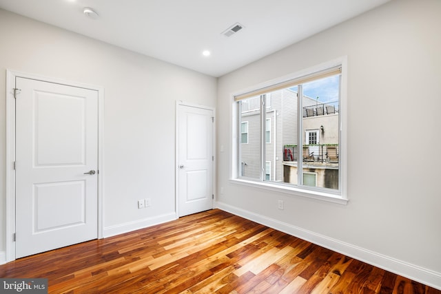 spare room featuring plenty of natural light and light hardwood / wood-style flooring