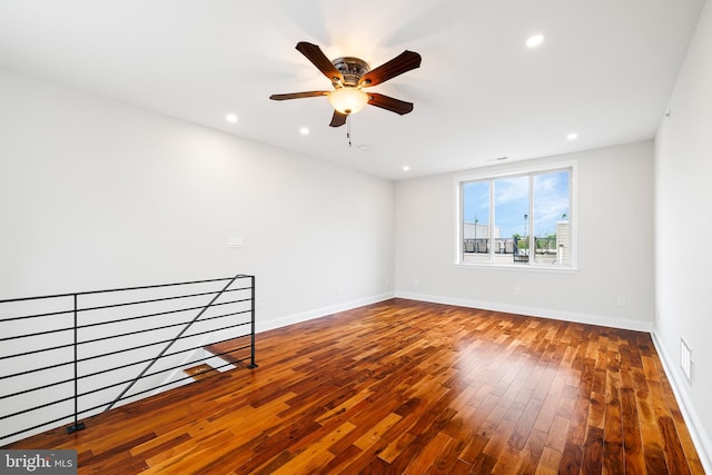 empty room featuring ceiling fan and hardwood / wood-style flooring