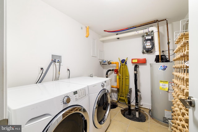 clothes washing area with water heater, light tile flooring, washer and clothes dryer, and washer hookup