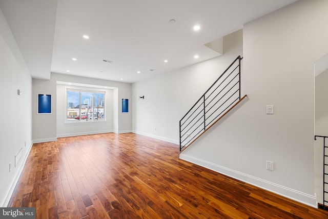 unfurnished living room featuring wood-type flooring