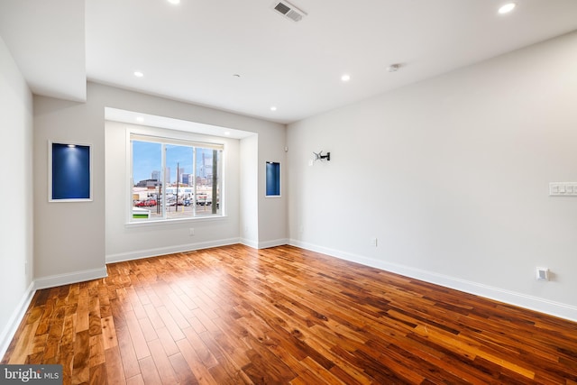 spare room featuring hardwood / wood-style floors