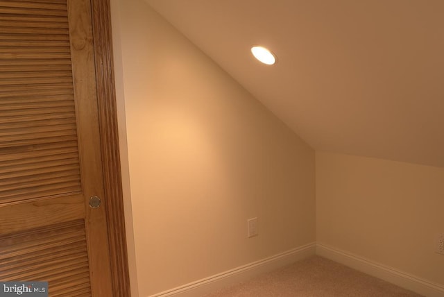 bonus room with carpet floors and lofted ceiling