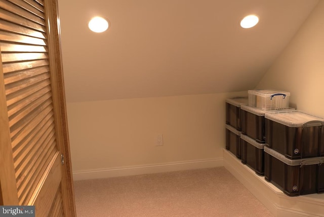 bonus room with light carpet and lofted ceiling