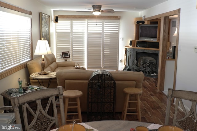 living room with wood-type flooring and ceiling fan