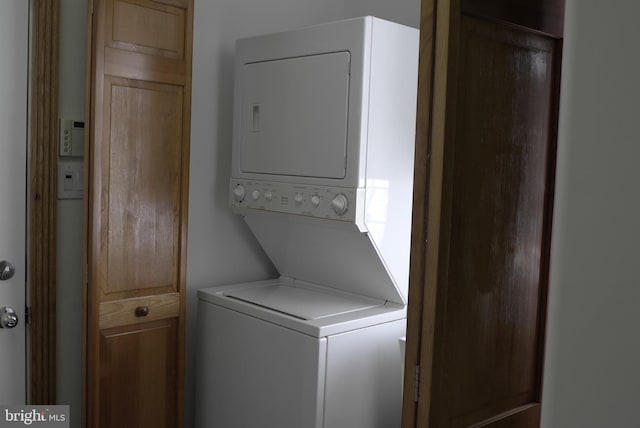 laundry room featuring stacked washer / drying machine