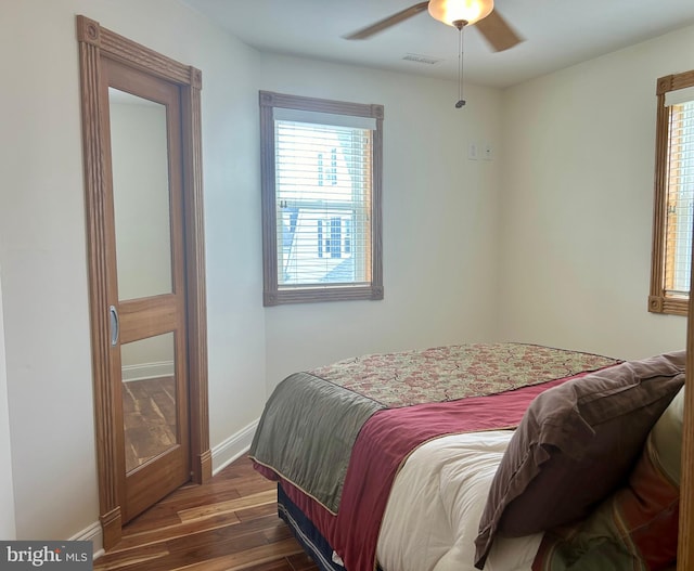 bedroom featuring ceiling fan and dark hardwood / wood-style flooring