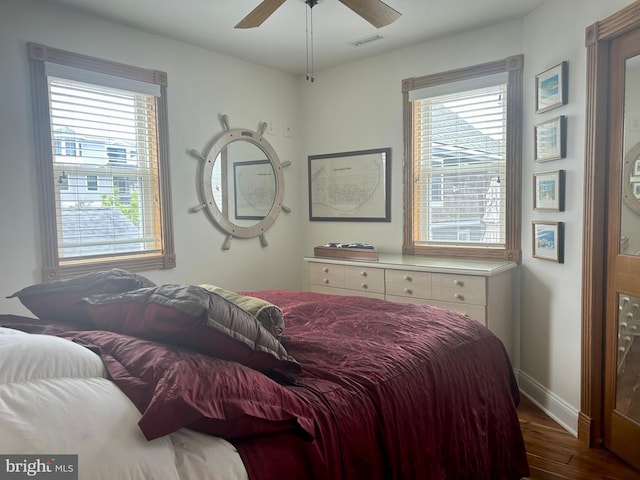 bedroom with ceiling fan and dark hardwood / wood-style floors