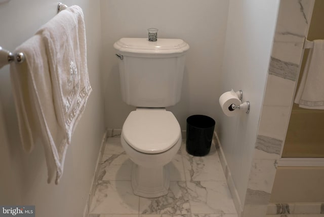 bathroom featuring tile flooring and toilet