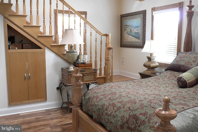 bedroom with dark hardwood / wood-style flooring