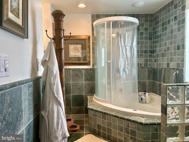 bathroom featuring independent shower and bath and tile walls