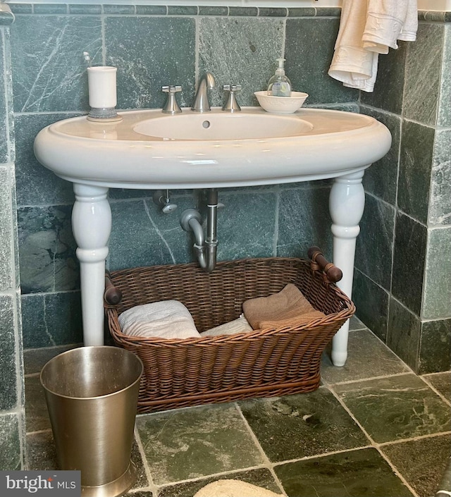 bathroom with tile flooring and tile walls