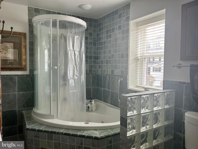 bathroom with toilet and tile walls