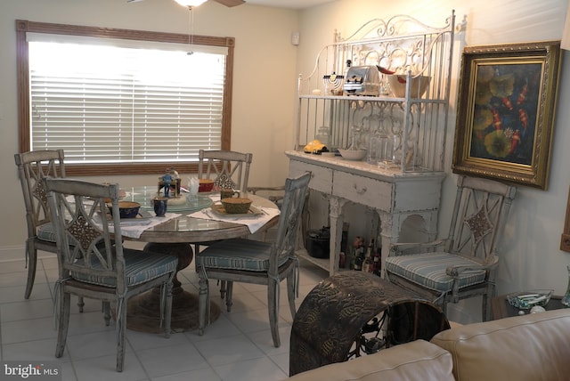 tiled dining room with ceiling fan