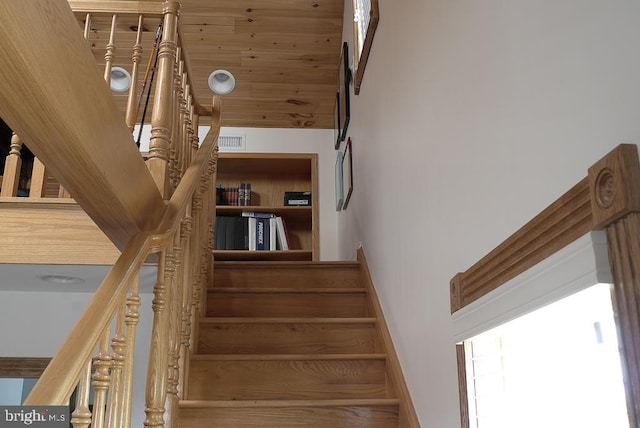 stairs with built in features and a towering ceiling