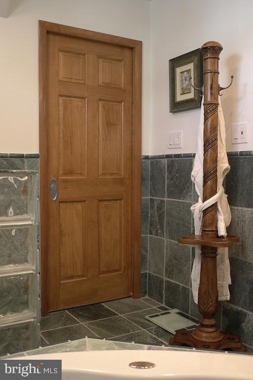 bathroom with tile walls and tile floors