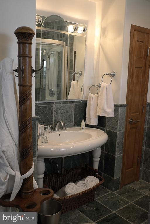 bathroom with tile walls, tile floors, and backsplash