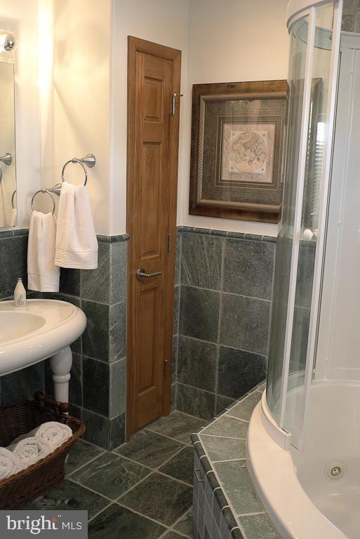 bathroom featuring tile walls and tile floors