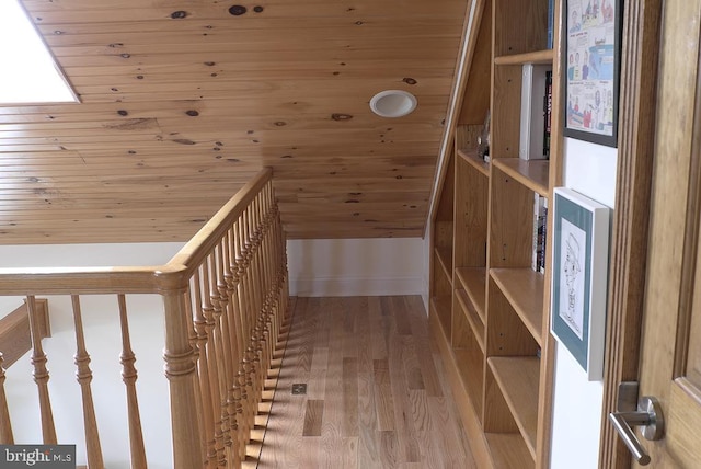 hallway with wood ceiling and hardwood / wood-style floors