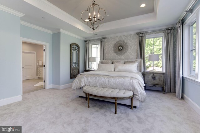 carpeted bedroom featuring ornamental molding, a chandelier, and a tray ceiling