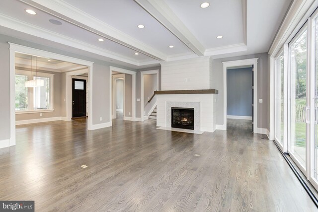 living room featuring a towering ceiling, a fireplace, and expansive windows