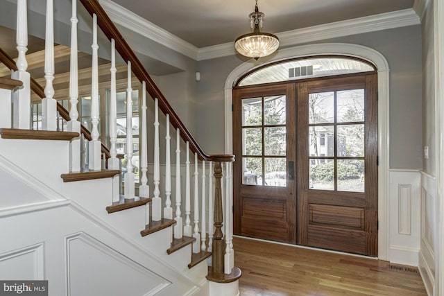 foyer entrance featuring french doors, hardwood / wood-style flooring, and plenty of natural light