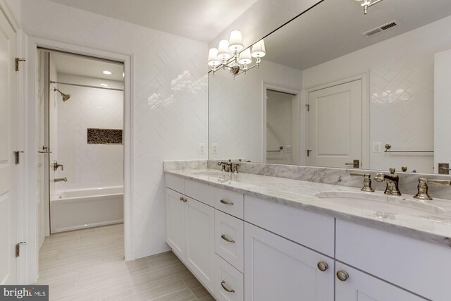 bathroom featuring shower / bath combination, vanity, and tile walls