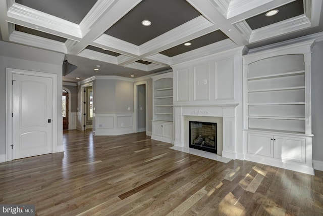 unfurnished living room with hardwood / wood-style floors, coffered ceiling, and built in features