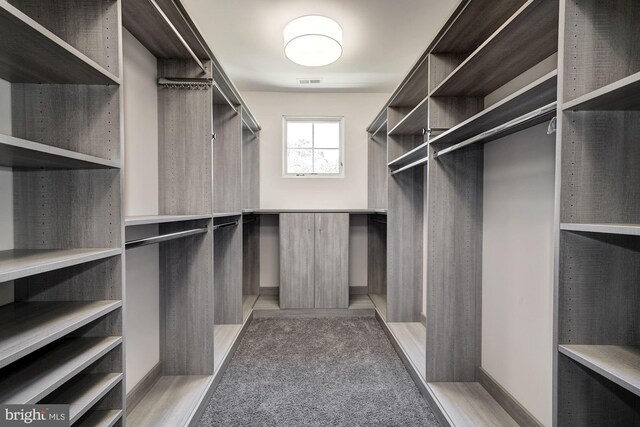 bedroom with an inviting chandelier, a tray ceiling, crown molding, and light colored carpet