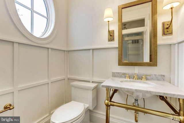 bathroom featuring sink and toilet