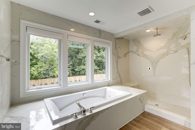 bathroom featuring separate shower and tub and hardwood / wood-style floors