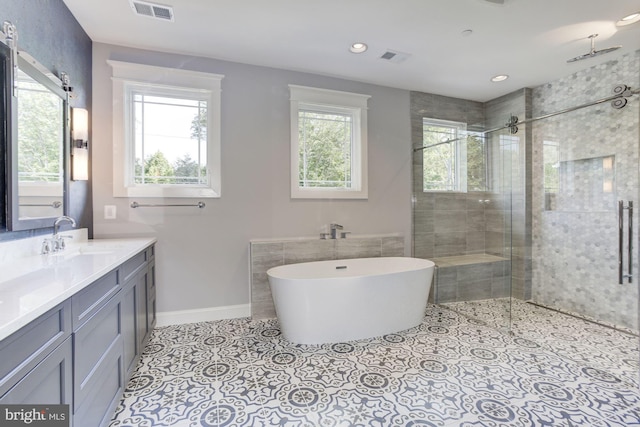 bathroom featuring shower with separate bathtub, tile patterned floors, vanity, and a healthy amount of sunlight