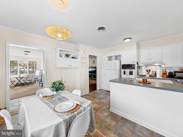 kitchen with white cabinets, pendant lighting, white appliances, and ornamental molding