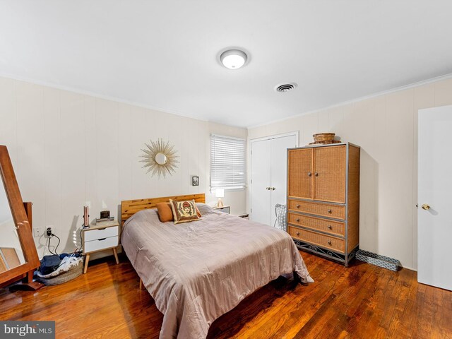 bedroom featuring dark hardwood / wood-style flooring and a closet