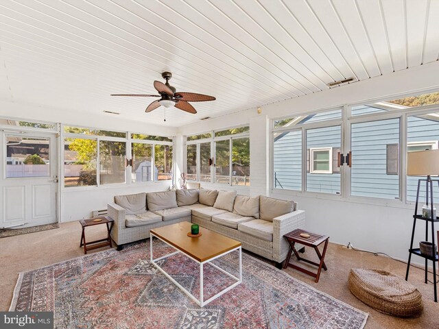 sunroom / solarium featuring ceiling fan