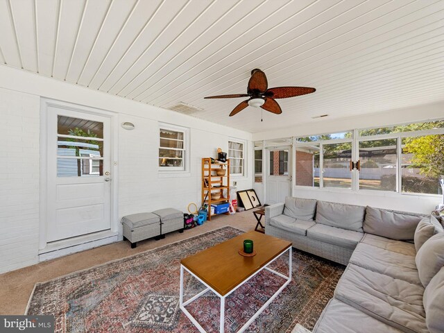 living room featuring carpet, ceiling fan, and wood ceiling