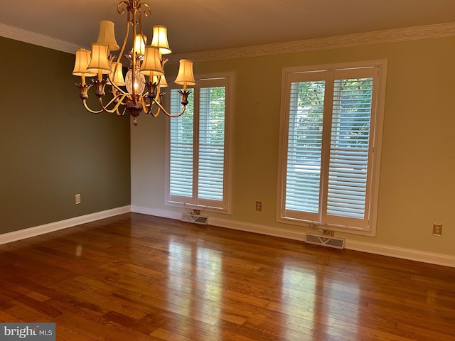 unfurnished room with crown molding, dark wood-type flooring, and a chandelier