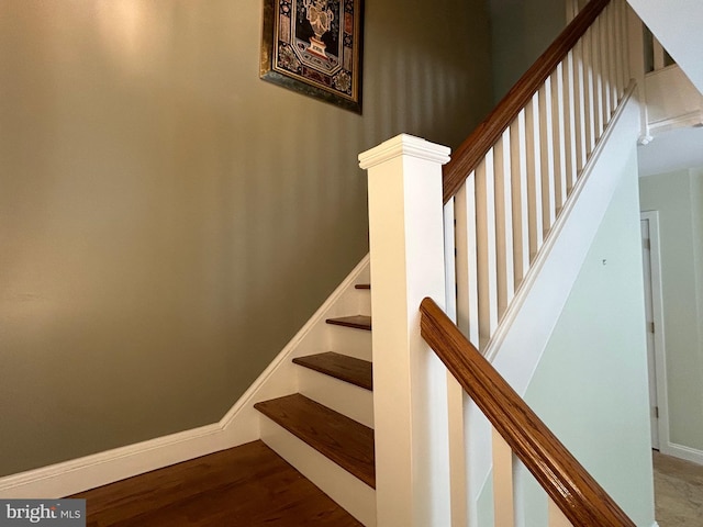 stairs featuring hardwood / wood-style flooring