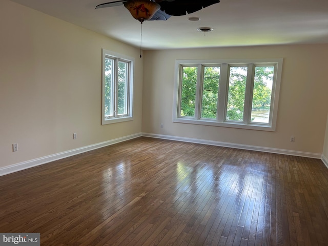 unfurnished room with dark hardwood / wood-style floors and ceiling fan