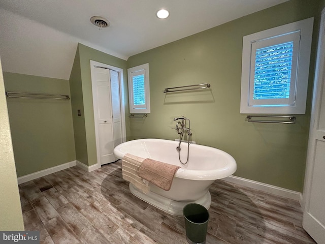 bathroom featuring a bath and wood-type flooring