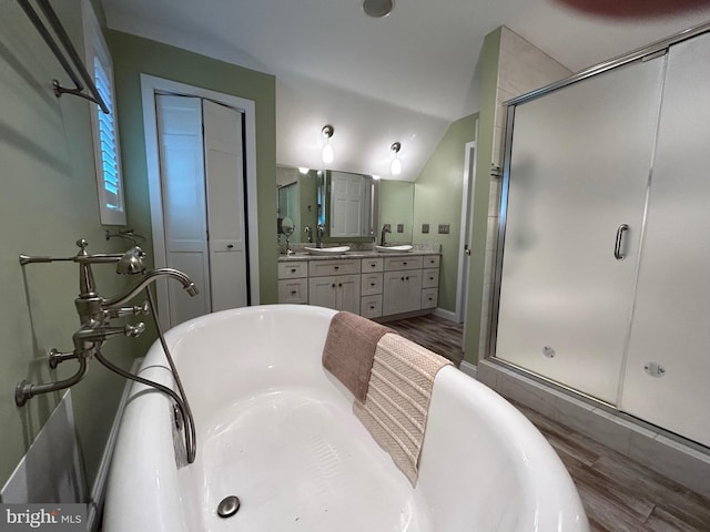 bathroom featuring plus walk in shower, vanity, wood-type flooring, and lofted ceiling