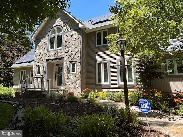 view of front of house featuring solar panels